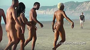 Busty interracial par nyder nøgenhed på stranden